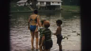 Superior Wisconsin (1973): Woman Standing On Dock With Children Runs After