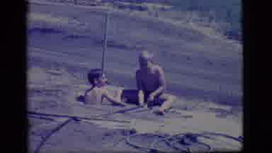 Ely Nevada-1968: Two Boys Playing In Mud On A Bright Sunny Day