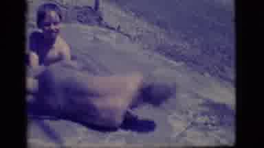 Ely Nevada (1968): Two Young Boys With Garden Hose Creating A Mud Pit And Rolling