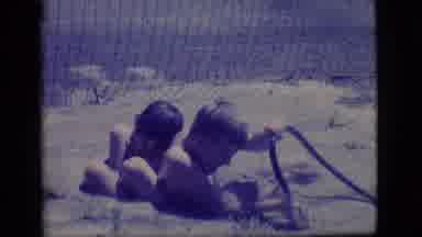 Ely Nevada (1968): Two Boys Outside Kicking And Splashing Around In A Mud Puddle