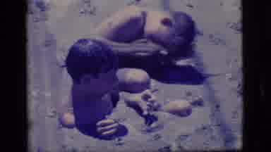Ely Nevada (1968): Two Boys Wrestle In Mud On A Bright Sunny Day