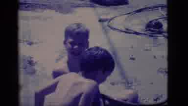 Ely Nevada (1968): Kids Filling A Large Hole Dug In The Dirt With Water To Make A