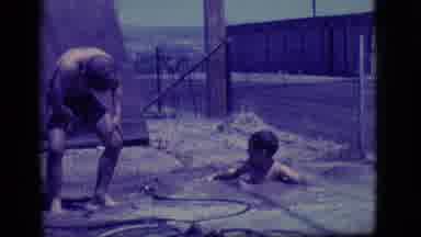 Ely Nevada-1968: Boys Playing In A Muddy Pool In Backyard