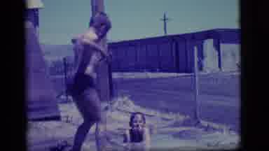 Ely Nevada (1968): Two Kids Playing In The Mud And Throwing Mud Up
