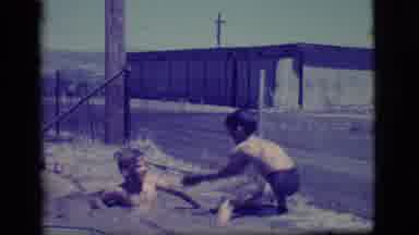 Ely Nevada (1968): Two Young Boys Sinking Into Mud Pits On Sunny Day And Throwing