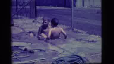 Ely Nevada (1968): Two Young Boys Playing In A Small Muddy Pool They Made By