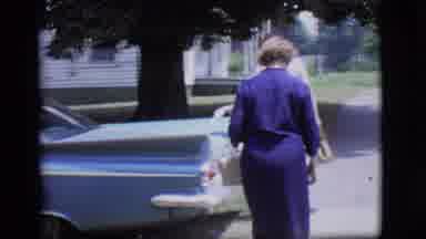 Des Moines Iowa (1966): Middle Aged Women Entering A Fancy Car And Cars Driving