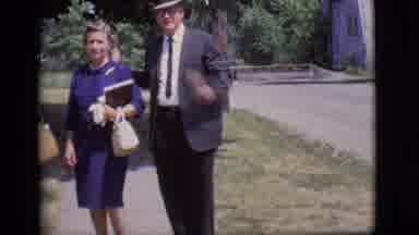 Des Moines Iowa (1966): Man In Suit Standing Beside A Woman Taking Off His Hat And