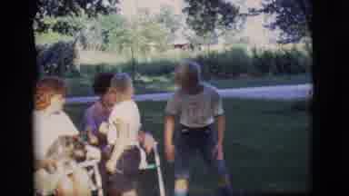 Des Moines Iowa (1966): Woman Wearing White Dress Sits With Grey Dog In Lap