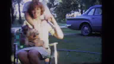 Des Moines Iowa (1966): Women Sitting On Chair Holding Her Dog While Her Son