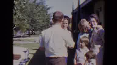 Evansville Indiana USA (1967): A Man In Smart Casual Clothes Walks Up To A Family