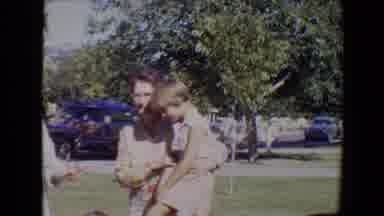 Evansville Indiana USA (1967): Woman Holds Child As Baby Plays In The Grass And