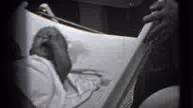 Trenton New Jersey-1941: Small Baby Wiggles As Mother Turns His Head
