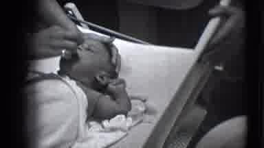 Trenton New Jersey-1941: Little Baby On A Bed Having Nose Cleaned