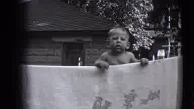 Trenton New Jersey (1941): Baby Reaching Over A Hanging Blanket