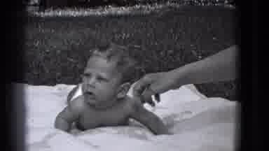 Trenton New Jersey (1941): A Baby Boy Lays On His Stomach Outside On A White