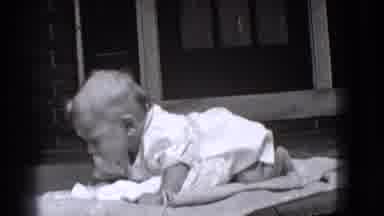 Trenton New Jersey (1941): Person Wearing Tan Pants Nudges Baby Wearing White