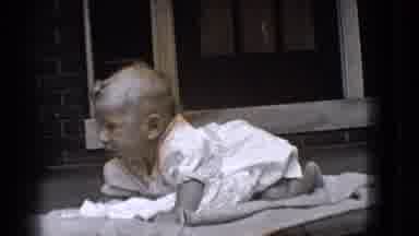 Trenton New Jersey (1941): A Baby Lying On A Blanket On His Stomach Looking Around