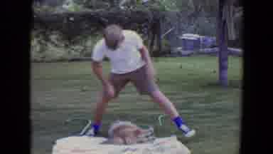 Flagstaff Arizona (1961): Man Wearing Tan Shorts Sets Tan Dog Free On A Clear Day