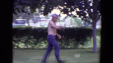 Flagstaff Arizona (1961): Man Wearing Blue Pants Walks On Green Grass Towards Tree