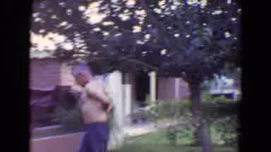 Flagstaff Arizona (1961): Shirtless Man Walking Towards House While Putting On