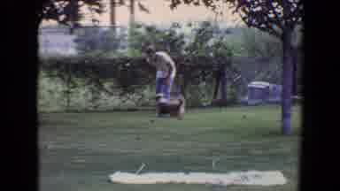 Flagstaff Arizona (1961): Man Playing Fetch With A Medium Sized Light Brown Dog