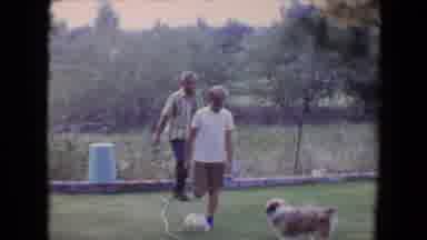Flagstaff Arizona (1961): Young Boy Kicks Ball To Play With Small Dog In Yard As
