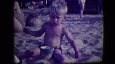 Asbury Park New Jersey (1946): Boy Wearing Black Shorts Sits On Sand With Blue