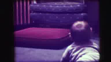 Union City New Jersey (1942): Small Baby Crawls Towards The Red Cushion On The