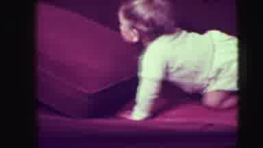 Union City New Jersey (1942): Small Adventurous Child Crawls Up Maroon Colored