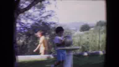 Davis California (1967): A Smiling Young Boy Has Fun Setting A White Ball Down