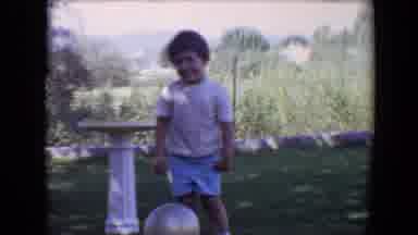 Davis California (1967): A Boy With A Ball On Ground Outside Standing In Front Of