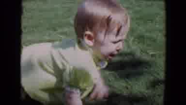 Davis California (1967): Young Child Crawls Across Lawn And Then Is Held By