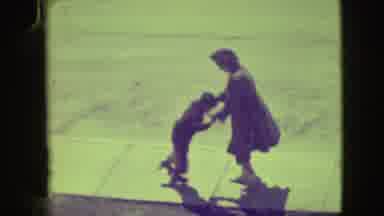 Elmwood Park Illinois (1945): Woman Helping A Child Learn To Rollerskate By