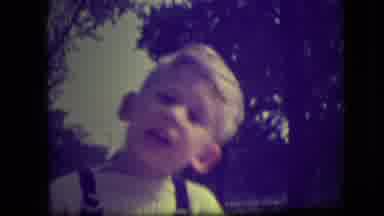 Park Ridge Illinois (1946): A Blonde Boy Wearing Suspenders Talks While Standing