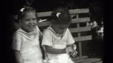 Levittown New York (1942): Young Children Playing Joyfully On Park Bench With Each