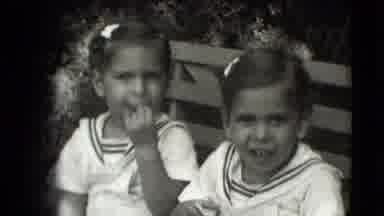 Levittown New York (1942): Twin Girls With Hair Bows Show Off Baby Teeth On A Park