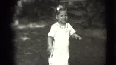 Levittown New York (1942): Two Young Girls In Matching Outfits Run Happily To