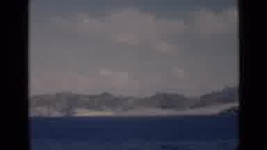 Aden Yemen (1946): A Mountainous And Sandy Shore Filmed From Across A Body Of