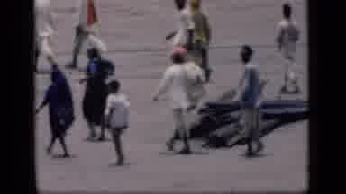 Bombay India (1946): Multiple African People Walking On A Street With A Stack Of