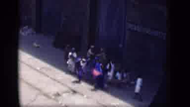 Bombay India (1946): Group Of People Touring Village Buildings On A Sunny Day
