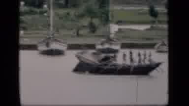 Bombay India (1946): A Troop Of People Seen Rowing A Boat With Many Oars On Muddy