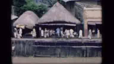 Bombay India (1946): Villagers Walk Past On Road In Front Of Huts Scene Changes To