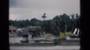 Bombay India (1946): Houses With A Pier Near Water And Coconut Palm Trees