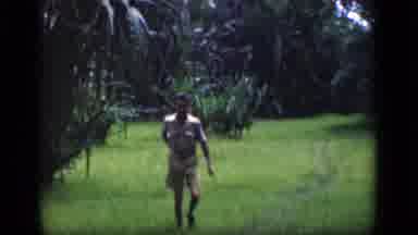 Bombay India-1946: Man Walking Through Tropical Field With Palm Trees