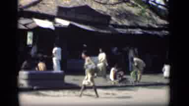 Bombay India (1946): A Few People Are Walking Working And Riding A Bike Down A