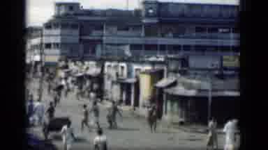 Bombay India (1946): Lots Of People Walk Around A Run Down Small City Area With