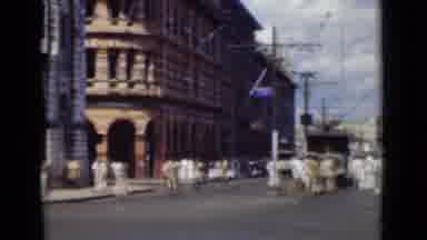 COLOMBO CEYLON-1946: City Street With Tall Brick Buildings And An Elephant At End