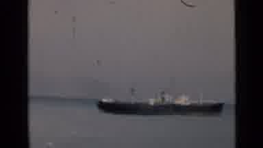 India-1946: A Large Cargo Ship Passing Slowly on the Water