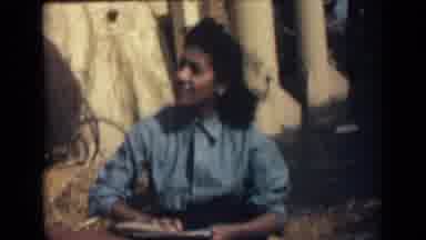 India (1946): Girl Working On Something In The Prairie In The Wind